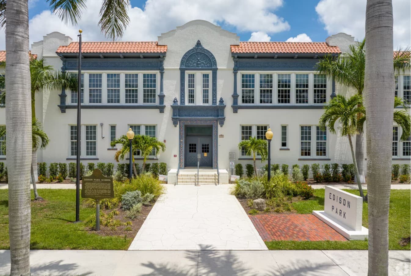 The Edison Park School building on Euclid Avenue, its arched blue entrance framed by palms and the school sign